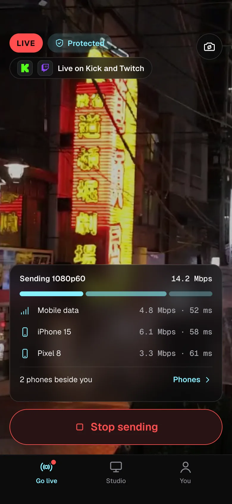 The Lumbus Live app on air: Protected, live on Kick and Twitch, sending 1080p60 over its own mobile connection and two phones beside you, with each one’s share of the stream.